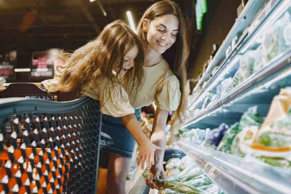 Customers buying items from super shop gondola rack.